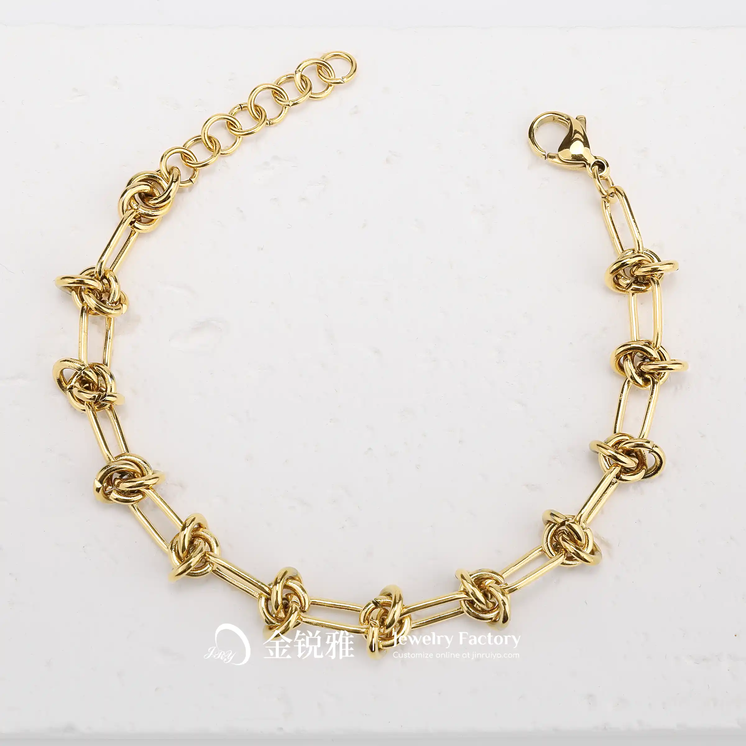 Still life shot of a gold stainless steel twist chain bracelet